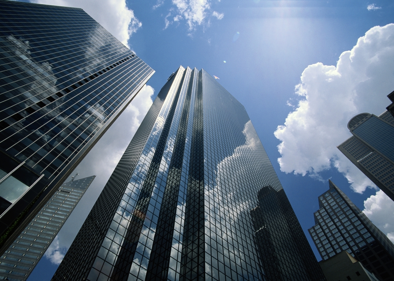 Office buildings reflecting clouds, low angle view -